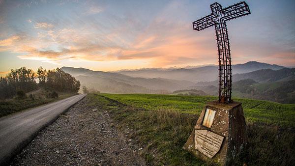 large cross on side of road in park